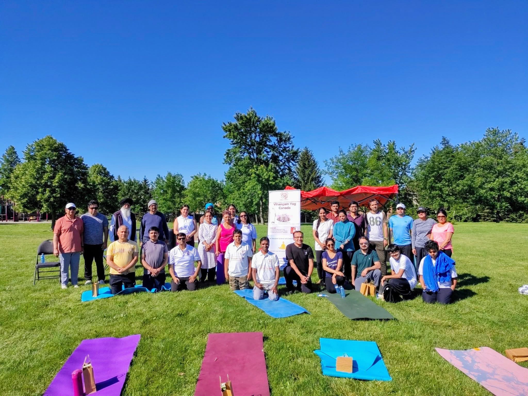 Vihangam Yoga Canada – large outdoor International Yoga Day event group photo in a park